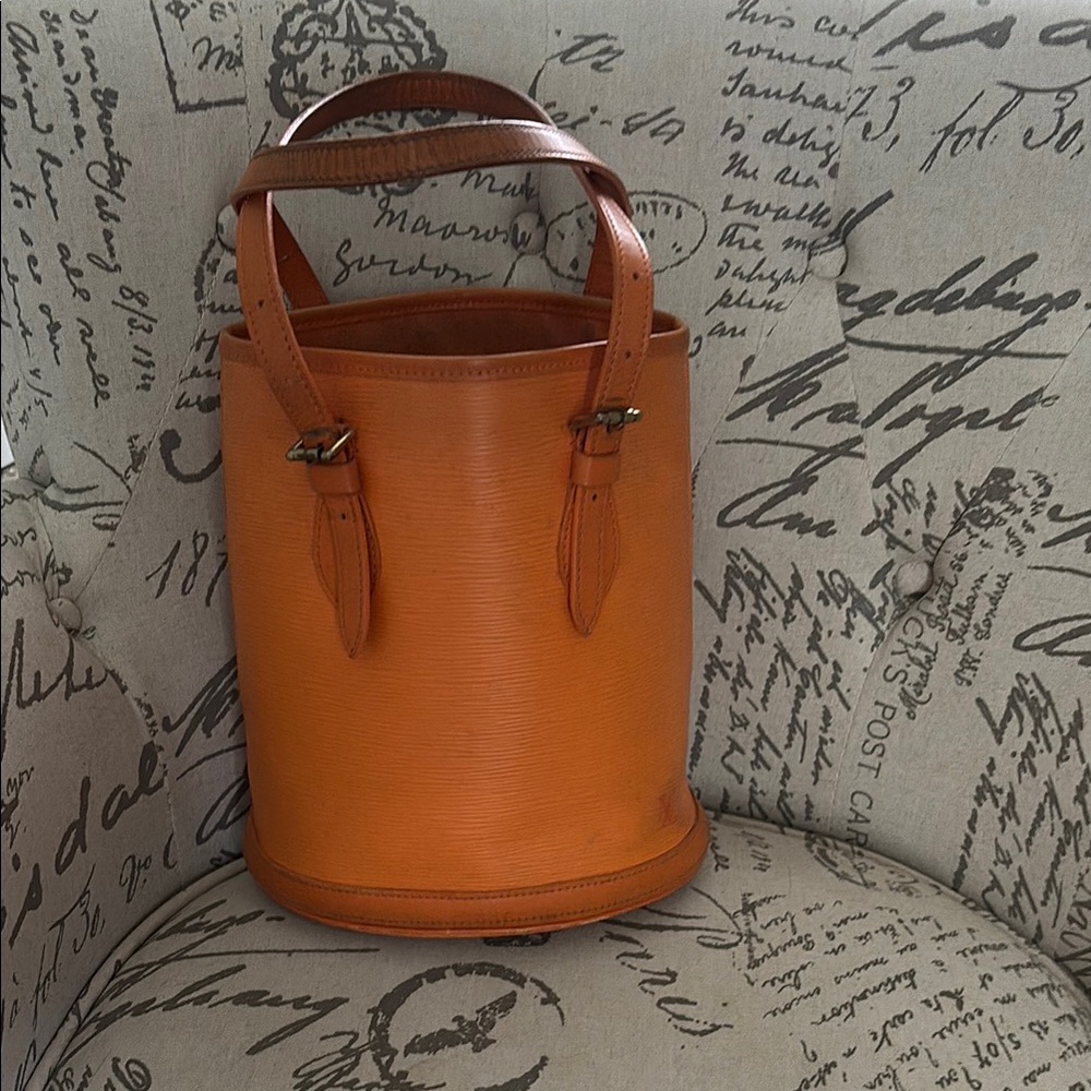Authentic Louis Vuitton Epi, leather petite bucket bag in orange